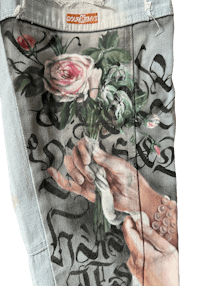 a pair of jeans with a hand holding a bouquet of roses